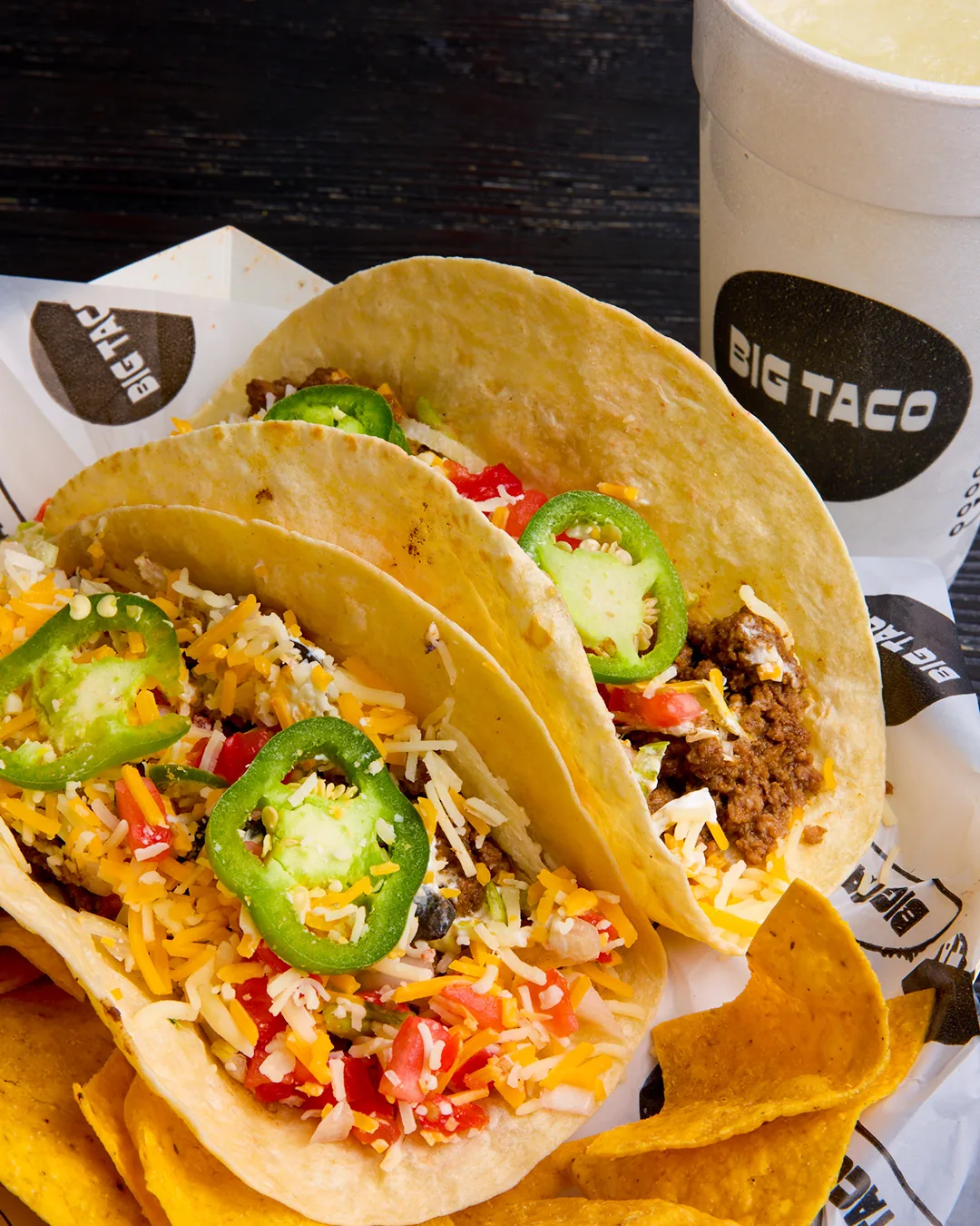 Two Big Taco tacos with tortilla chips and a drink, the Taco Tuesday deal